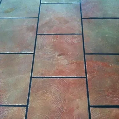 Basement epoxy flooring installation process in Menomonee Falls, Wisconsin with skilled professionals at work