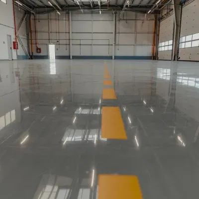 Professional basement floor coating application in Wauwatosa, WI, showcasing a sleek and durable finish