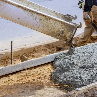 Concrete curb and gutter construction in Menomonee Falls, WI, showcasing skilled workers at the site
