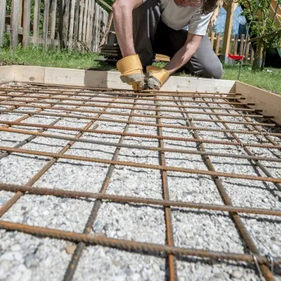Concrete curb installation process in Pewaukee, Wisconsin showcasing rebar placement and preparation