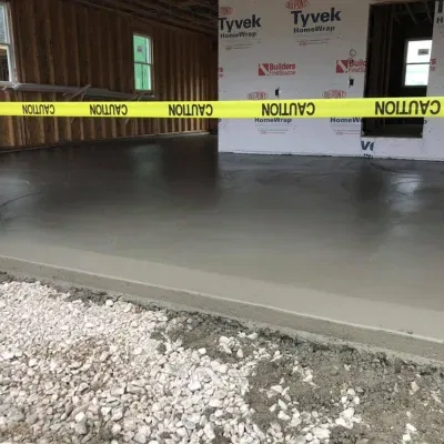 Concrete installation process for residential flooring in a new construction site during daylight hours