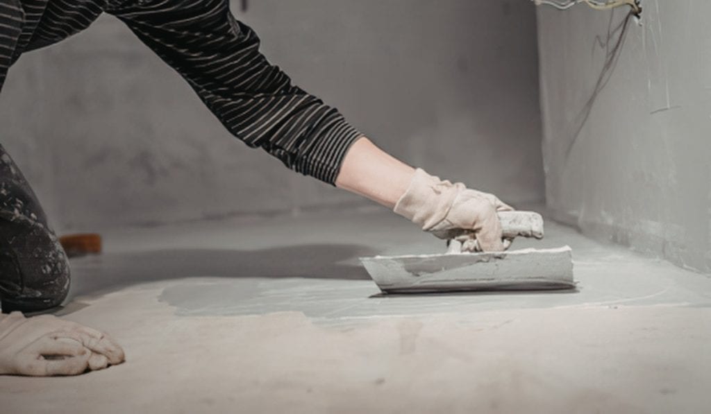 Concrete floor being coated with sealer
