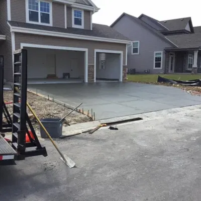 Concrete slab installation for driveway and garage at residential property in suburban area