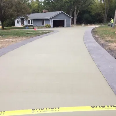 Decorative concrete pathways enhance landscape in residential area during sunny daytime