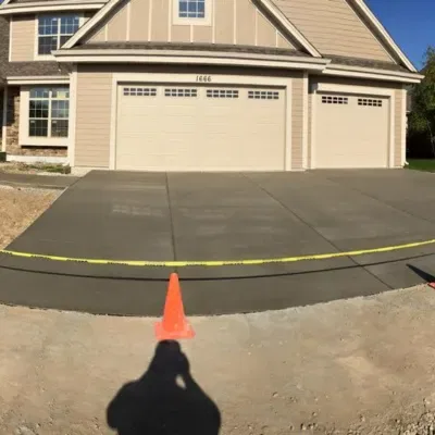 Decorative concrete installation progress in Pewaukee, WI showcasing freshly poured driveway