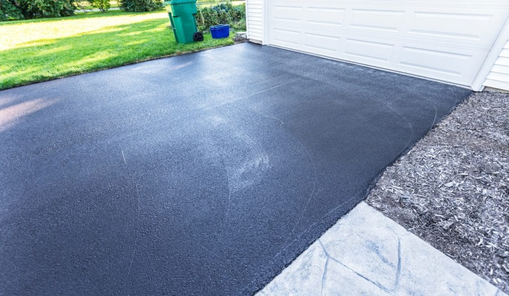 Contractors removing old concrete driveway sections