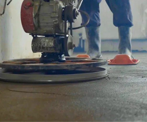 Installing eco-friendly concrete floor in Sussex with specialized equipment for sustainable building practices