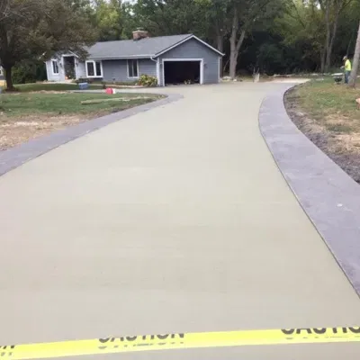 Concrete garage slab installation in Hartland WI creates smooth driveway surface enhancing curb appeal and functionality