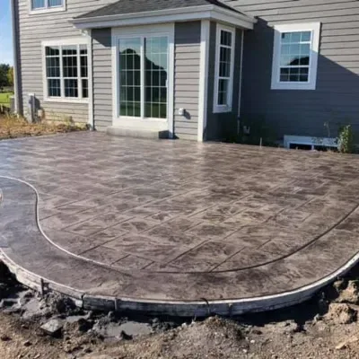 Concrete patio installation process in Waukesha showcasing detailed work on a residential property