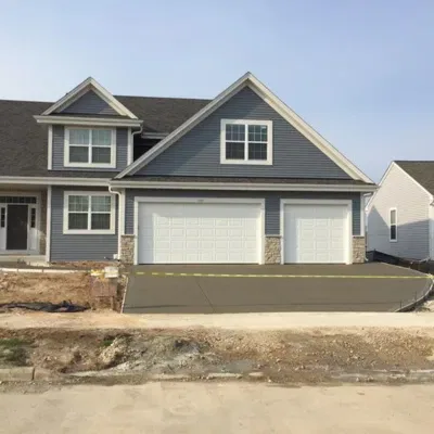 New patio flatwork completed in Sussex, WI showcasing modern residential driveway design