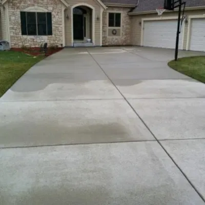 Poured concrete driveway installation in Sussex, Wisconsin enhancing curb appeal and functionality of the property