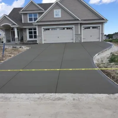 Newly poured concrete driveway in Waukesha enhances home curb appeal and functionality