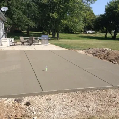 Stunning stamped concrete design project in Brookfield WI showcasing a newly poured patio area surrounded by nature