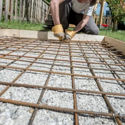 Concrete curb installation process in Pewaukee, Wisconsin showcasing rebar placement and preparation
