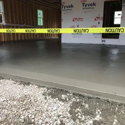 Concrete installation process for residential flooring in a new construction site during daylight hours