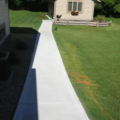 Custom concrete walkway design enhances outdoor access and aesthetic appeal in residential backyard