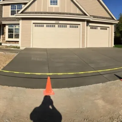 Decorative concrete installation progress in Pewaukee, WI showcasing freshly poured driveway