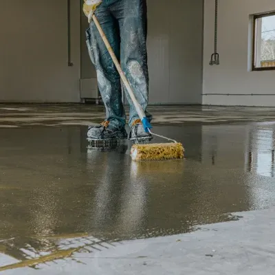 Applying epoxy paint to a concrete floor in Delafield WI by a professional contractor