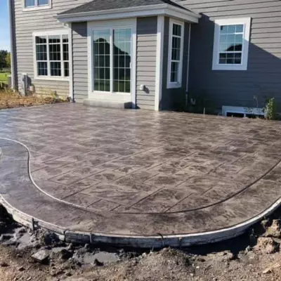 Concrete patio installation process in Waukesha showcasing detailed work on a residential property