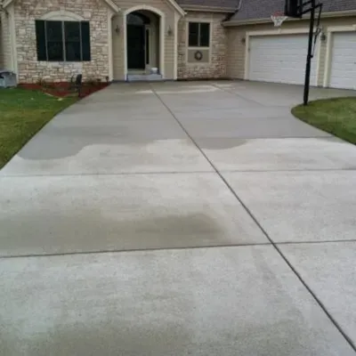 Poured concrete driveway installation in Sussex, Wisconsin enhancing curb appeal and functionality of the property