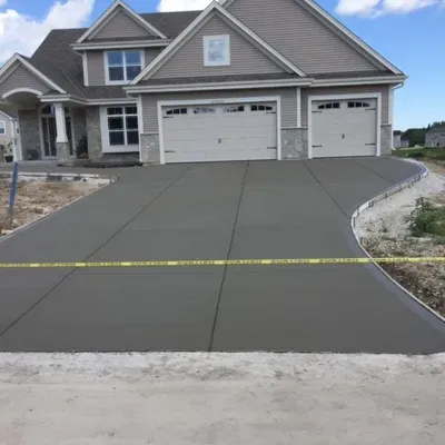 Newly poured concrete driveway in Waukesha enhances home curb appeal and functionality