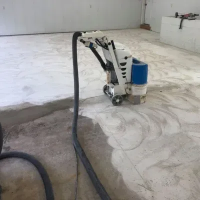 Epoxy floor preparation on showroom floor in Hartland, Wisconsin during renovation process