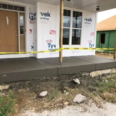 Slab foundation construction in Hartland, WI showing a prepared porch area with caution tape