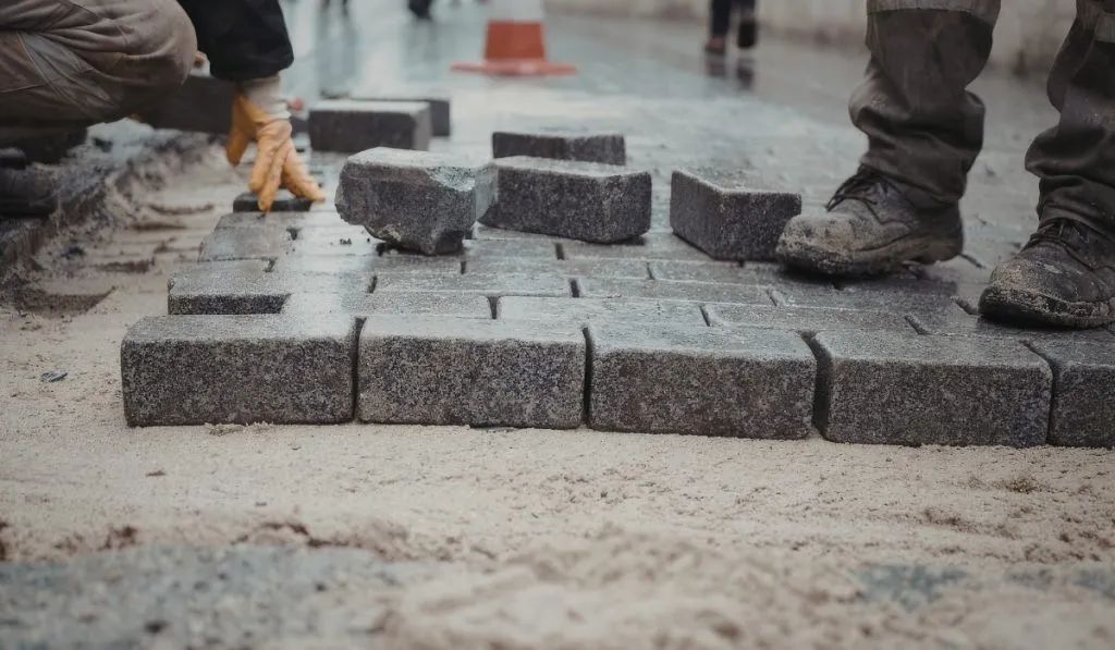 Comparison of stamped concrete and paver surfaces in driveway